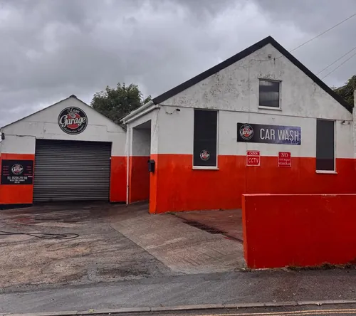 Commercial building render after softwash — colour restored