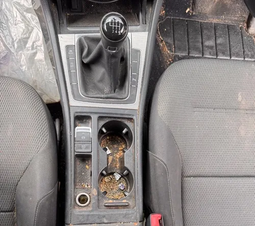Car centre console before deep clean — ingrained dirt and debris