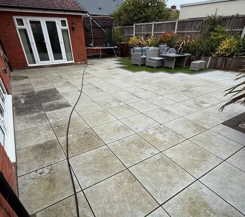 Patio paving before pressure washing — stained and dulled slabs