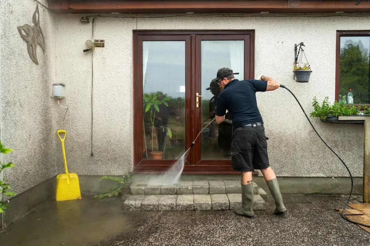 Hatton's Cleaning Services pressure washing around drains and patio entry