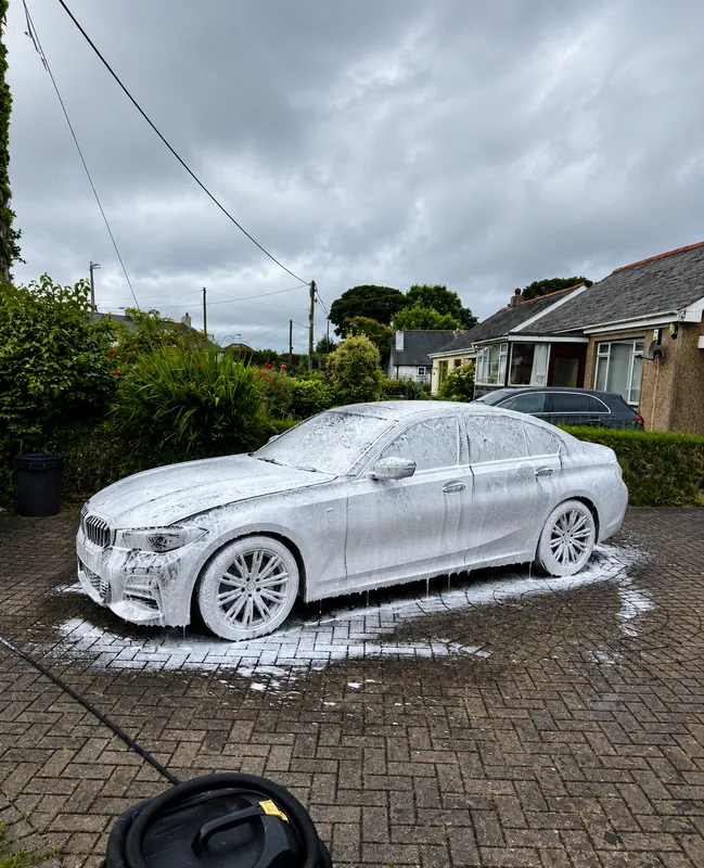 BMW covered in snow foam mid-valet — mobile car wash in Cornwall